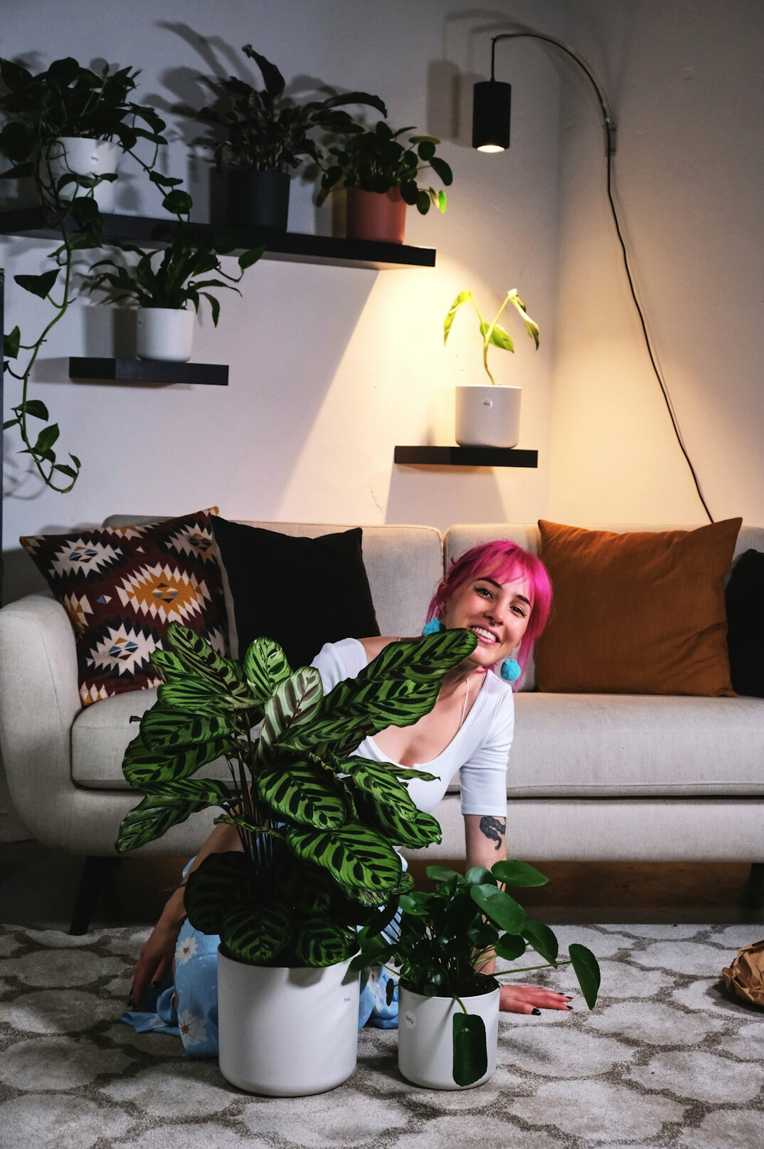 woman caring for indoor plants